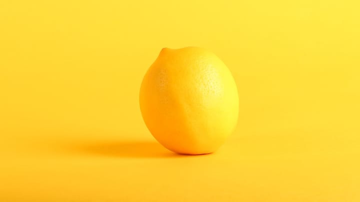A beautiful lemon against a yellow background